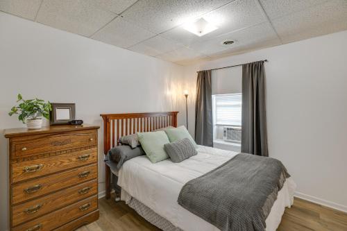 a bedroom with a bed and a dresser and a window at Bright Yankton Apartment Near Meridian Bridge in Yankton
