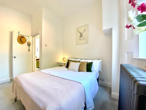 ロンドンにあるThe Barnsbury, London Apartment with WIFIのベッドルーム1室(白いシーツ付きのベッド1台、窓付)