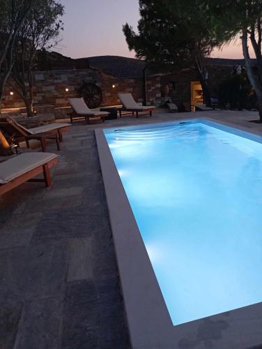a large swimming pool with blue lighting in a backyard at Villa Art Natalie in Kithnos