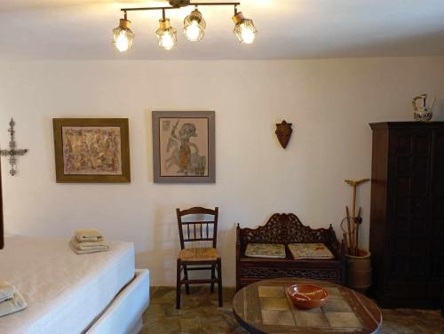 a bedroom with a bed and a table and a chair at Villa Art Natalie in Kithnos