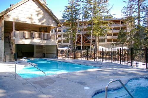 a swimming pool in front of a apartment building at #402 Grand Lodge South Penthouse in Government Camp
