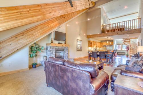 a living room with leather furniture and a fireplace at #402 Grand Lodge South Penthouse in Government Camp