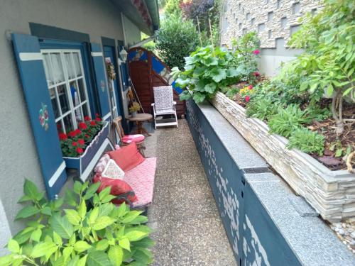 a porch of a house with flowers and plants at Haus Wiesental in Kleines Wiesental