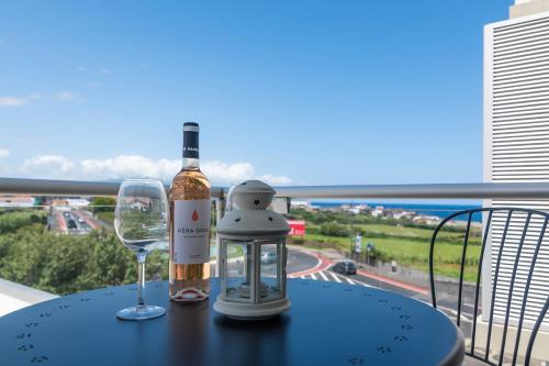 a bottle of wine and a glass on a table at Belavista Oceanside in Ribeira Grande