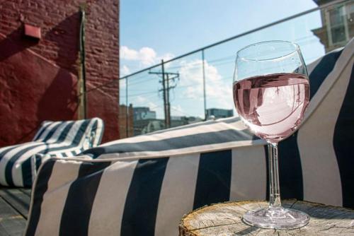 a glass of wine sitting on top of a table at Great Parkside Apt w Private Patio and Sun Deck in Cincinnati