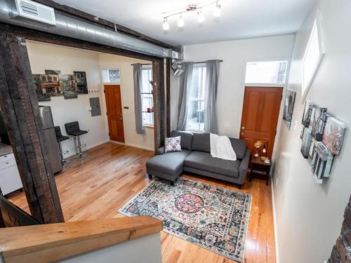 a living room with a couch and a rug at Cozy OTR Home with Private Roof Deck in Cincinnati