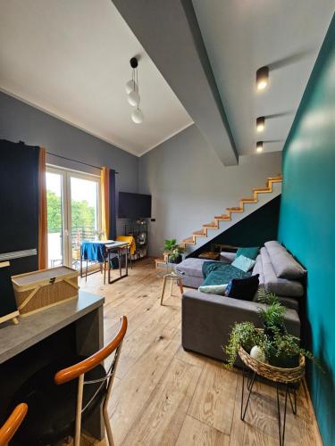 a living room with a couch and a staircase at Złota Widokówka in Jaworze
