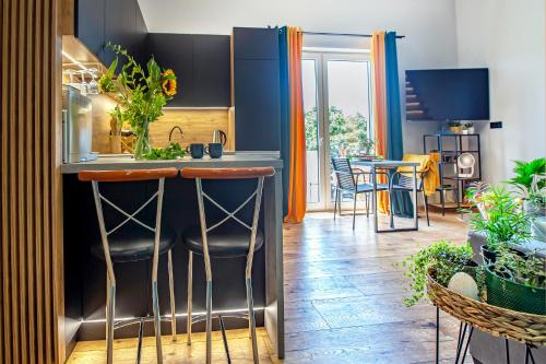 a kitchen with a bar with a sink and some plants at Złota Widokówka in Jaworze