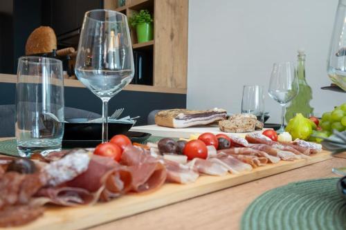 a table with wine glasses and meats and cheese at Active holiday in nature on agritourism! Make wine or olive oil!!! in Posedarje