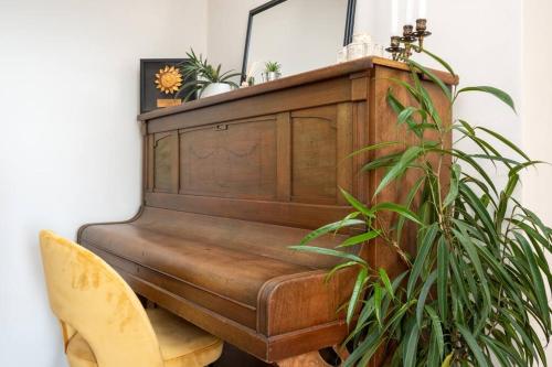 a wooden piano with a potted plant next to it at Active holiday in nature on agritourism! Make wine or olive oil!!! in Posedarje