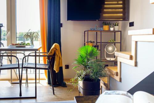 a living room with a table and chairs with plants at Złota Widokówka in Jaworze