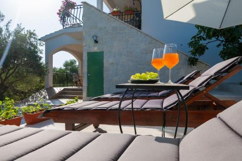 a table with glasses of juice and a bowl of fruit at Active holiday in nature on agritourism! Make wine or olive oil!!! in Posedarje