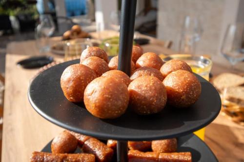 a black plate with donuts on a table at Active holiday in nature on agritourism! Make wine or olive oil!!! in Posedarje