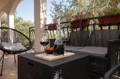 a table with two glasses of wine on a patio at Active holiday in nature on agritourism! Make wine or olive oil!!! in Posedarje