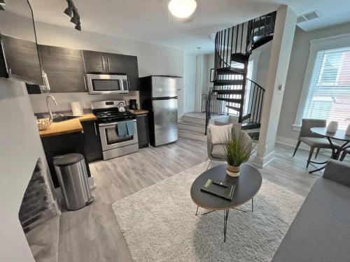 a living room with a couch and a table in a kitchen at Quiet 1-Bedroom Loft near Entertainment District in Cincinnati