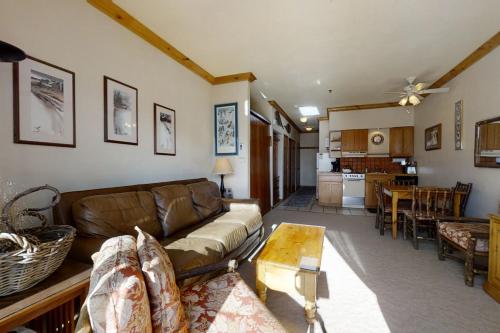 a living room with a couch and a table at Snow Flower 309 in Steamboat Springs