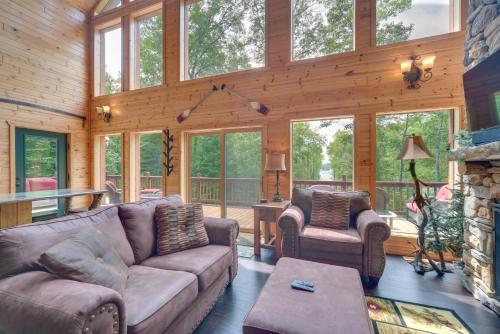 a living room with a couch and chairs in a cabin at Paddle Ready Hayward Lake View Retreat with BBQ in Hayward
