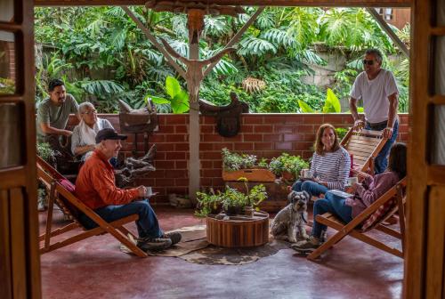 a group of people sitting in hammocks in a patio at Carolina Egg Gasthaus in Oxapampa
