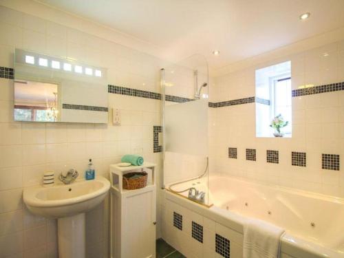 a bathroom with a sink and a tub and a toilet and a sink at Dune Cottage sleeps 2 with parking pet friendly close to St Ives & Penzance in Saint Erth
