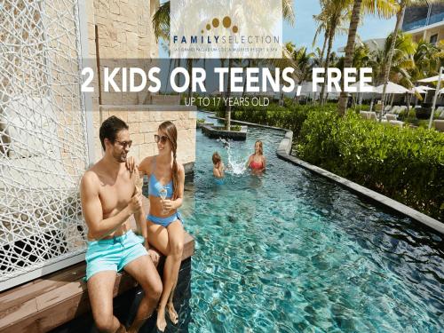 a man and woman in bathing suits sitting in a swimming pool at Family Selection at Grand Palladium Select Costa Mujeres - All Inclusive in Cancún
