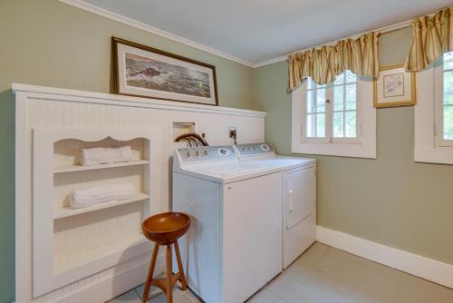 a laundry room with a washing machine and a stool at Cozy Vacation Rental Home Near Lake Winnipesaukee! in Wolfeboro