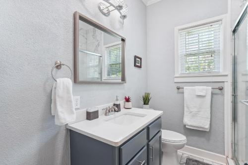 a bathroom with a sink and a toilet and a mirror at Charming Apartment Retreat in Historic Jefferson! in Jefferson