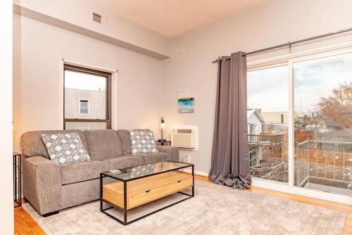 a living room with a couch and a large window at Mt Adams 1BR Great Location Steps from Monastery in Cincinnati