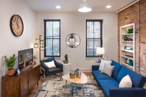 a living room with a blue couch and a table at WALK TO ALL in Over The Rhine Cincinnati in Cincinnati