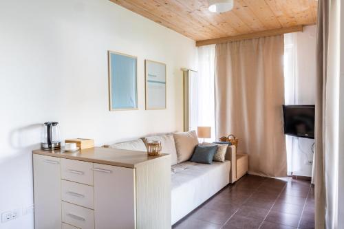 a living room with a couch and a tv at Apartment Rosemary in Topolšica