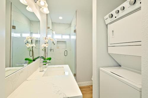 a white bathroom with a sink and a mirror at Sunshine Fun Time in Newport Beach