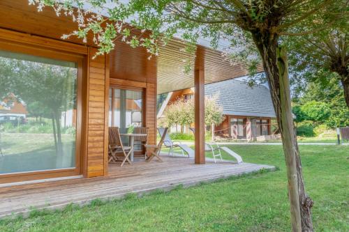 a wooden deck with a table on the side of a house at Apartment Rosemary in Topolšica