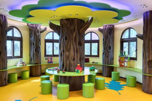 a childrens room with a tree in the ceiling at Parklane, a Luxury Collection Resort & Spa, Limassol in Limassol