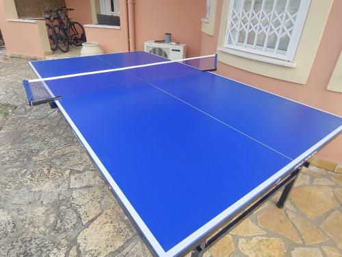 a blue ping pong table in front of a building at Captain Alex Villa 1 in Dafnila