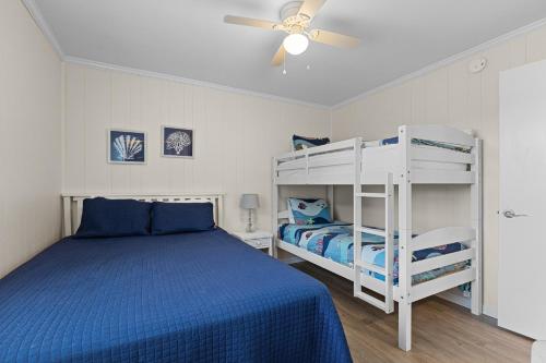 a bedroom with two bunk beds and a ceiling fan at Southwinds F6 in Atlantic Beach