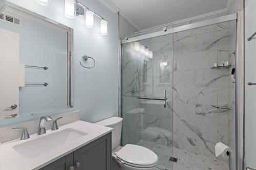 a bathroom with a shower and a toilet and a sink at Southwinds F6 in Atlantic Beach
