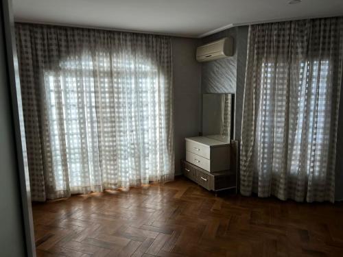 a room with a dresser and a window with curtains at Centre ville hay Riad 06 69 soixante-huit trente-huit vingt-huit in Ifrane