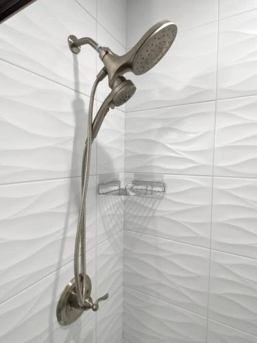 a shower with a shower head in a bathroom at SWIZZLE Explore OTR and Downtown from Rhinegeist in Cincinnati