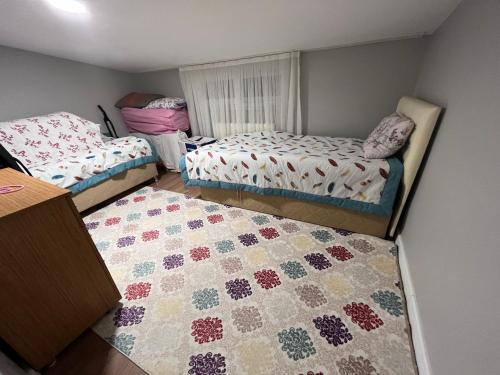 a room with two beds and a quilt on the floor at Sahin Place in Istanbul