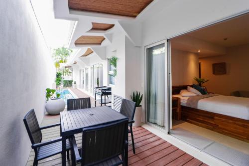 a room with a bed and a table and chairs at Hermosa Wave C1 & C2 in Playa Hermosa