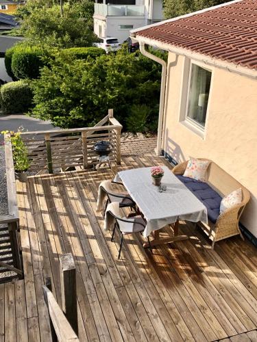 a wooden deck with a table and chairs on it at GG Village in Askim