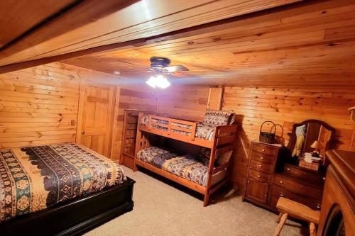 a bedroom with two beds in a log cabin at Home Sweet Log in Wisconsin Dells