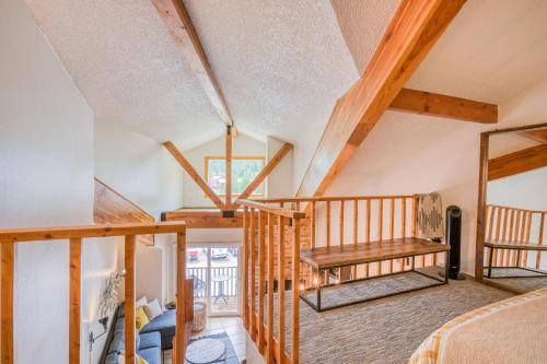 a room with a loft with a bed and a mirror at Lift West #215 in Red River