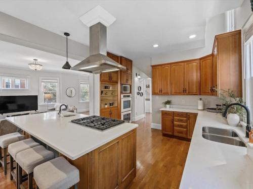 a kitchen with wooden cabinets and a white counter top at Deluxe 6 Bedroom 3 Min to Downtown w 2-car Driveway in Cincinnati