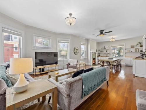 a living room with a couch and a tv at Deluxe 6 Bedroom 3 Min to Downtown w 2-car Driveway in Cincinnati
