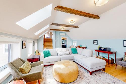 un soggiorno con divano e sedie bianchi di Waterbury-Stowe Farmhouse Units 1-3 a Waterbury