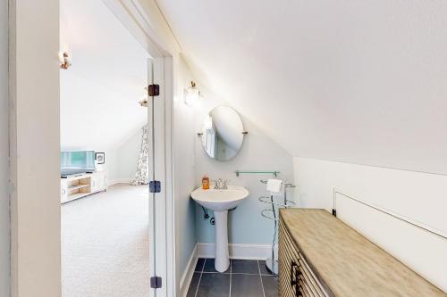 a bathroom with a sink and a mirror at Waterbury-Stowe Farmhouse Units 1-3 in Waterbury