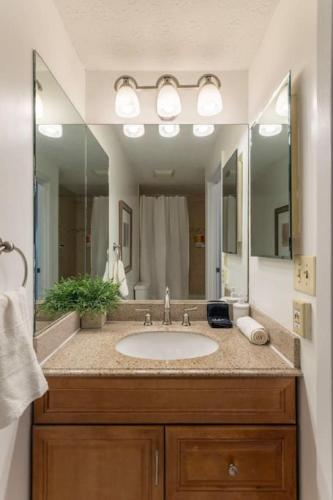 a bathroom with a sink and a large mirror at Adorable MtAdams 2BR near it all in Cincinnati