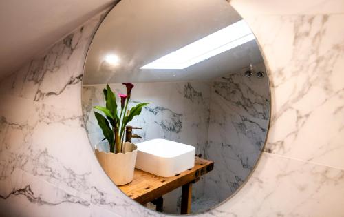 a bathroom with a mirror and a sink at Casa D'Mina in Redondela