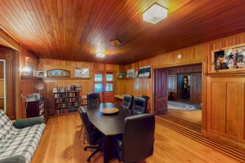 a dining room with a table and a couch at Garden Island's Maple in Charlotte