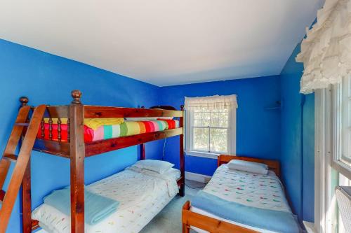 a bedroom with two bunk beds in a blue room at Garden Island's Maple in Charlotte
